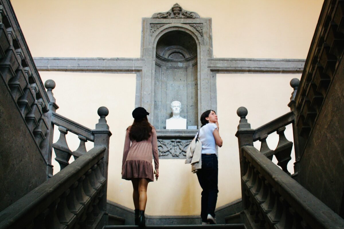 mujer viajera en museo caminando entre salas de exposición